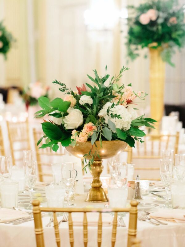 set tables in a ballroom for a wedding