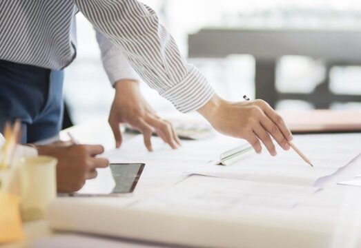 people working on charts at a table